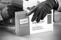 A poll worker handles mail-in ballots.