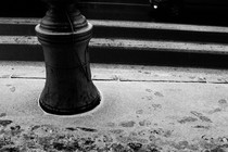 A street with footprints in the light layer of dusty snow