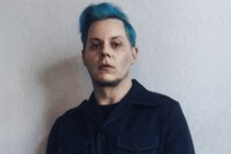 soft-focus photo of Jack White with blue hair and dark collared shirt