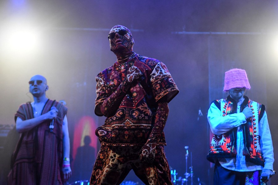 Three performers strike a pose onstage.
