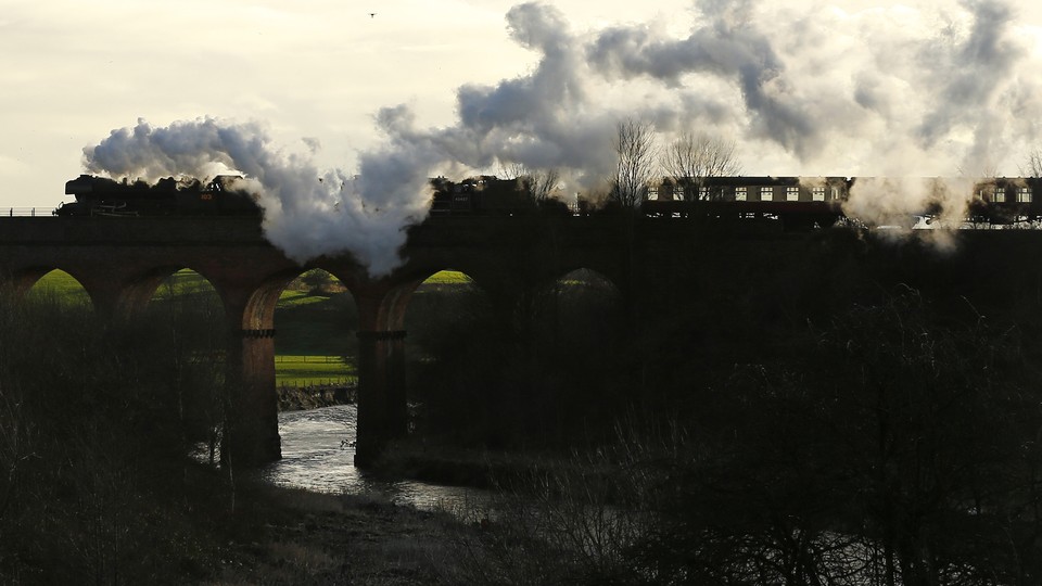 The Flying Scotsman steam engine passes over a viaduct in Bury, Britain, in 2016. 