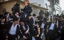 Mounted members of the Israeli security forces try to disperse ultra-Orthodox Jewish protesters as they block a road during a demonstration against army recruitment, in Bnei Brak, Israel, August 6, 2018.