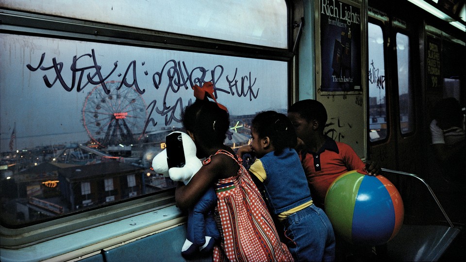 Kids looking out the window in the New York subway