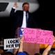 A man holds a "Drain the Swamp in Washington, D.C.," sign at a campaign event for Donald Trump