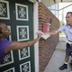 A postal service employee delivering mail.