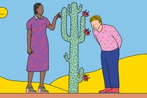 One person touches the needles of a cactus while another smells the cactus flowers.