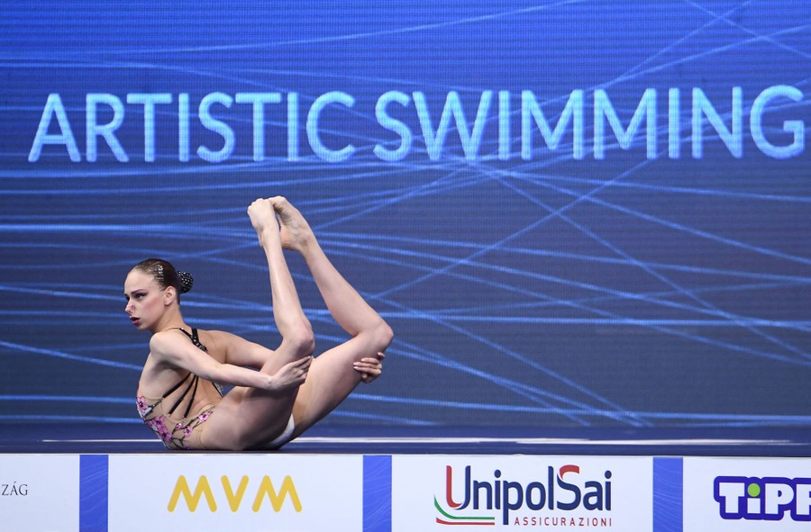 An artistic swimmer poses during a competition.