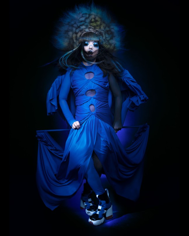 Björk in a blue gown with a large headdress