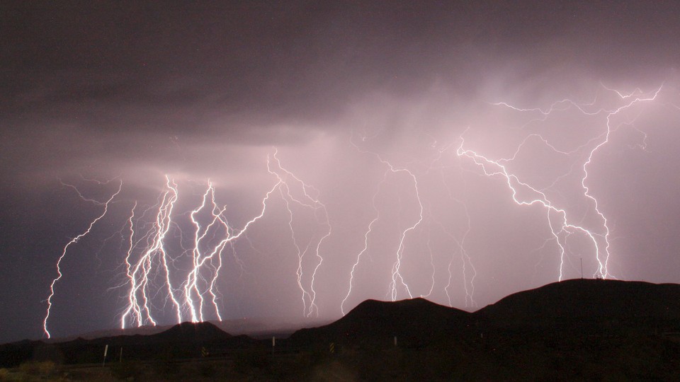 A long-exposure photograph shows more than a dozen lightning bolts illuminating the night sky north of Barstow, California, in 2015.
