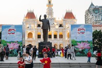 An image of people walking on a pedestrian street near the Ho Chi Minh Monument in Ho Chi Minh City, Vietnam