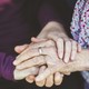 Two hands holding each other