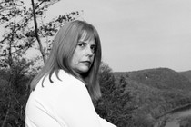 Tami Barthen seated outside her home