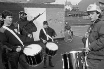 A black and white photo of boys playing drums in Belfast in 1991