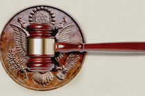 A gavel hitting the wooden seal of the United States