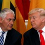 Donald Trump and Rex Tillerson are seated next to each other