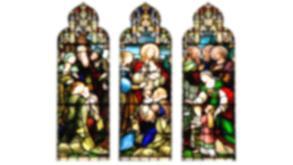 A blurred image of three stained-glass windows