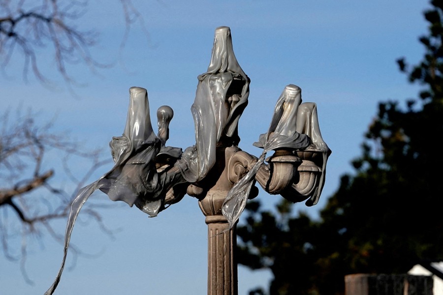 An ornamental street light with the melted plastic of five lamps draped across it
