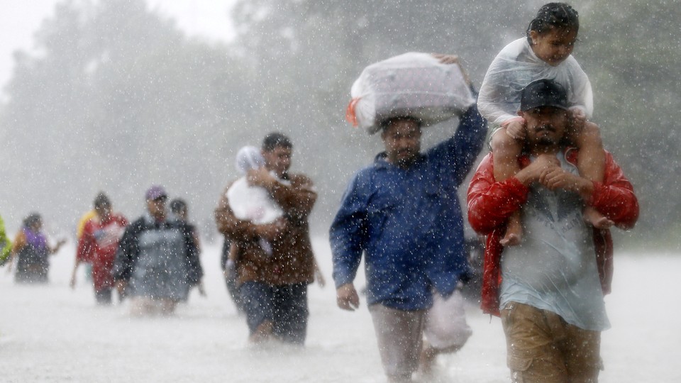 Houston residents wade through floodwaters and heavy rain.