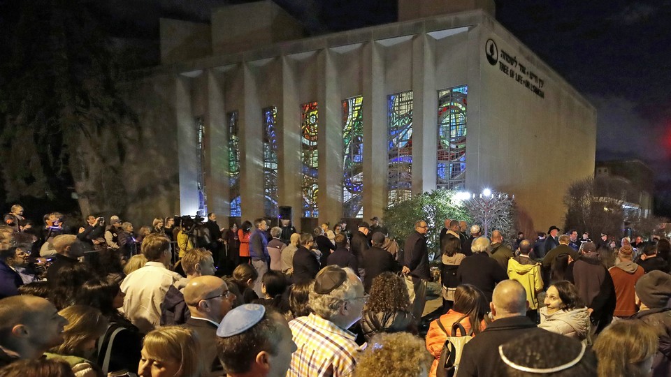 People gather outside the Tree of Life synagogue on the first night of Hanukkah, December 2, 2018, in the Squirrel Hill neighborhood of Pittsburgh.