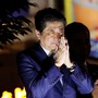 Prime Minister Shinzo Abe closes his hands in thanks at a campaign rally.