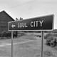 Sign to Soul City next to house
