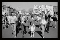A black-and white still from the documentary "Deaf President Now!" showing Gallaudet University student protesters assembled outside.