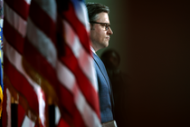 Mike Johnson with an American flag