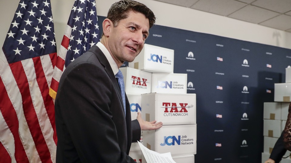 House Speaker Paul Ryan pointing to boxes of petitions supporting a tax-reform bill