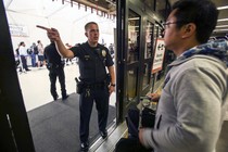 A police officer directs a passenger at Terminal 7 in Los Angeles International Airport, Sunday, Aug. 28, 2016.