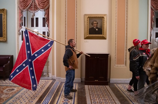 A Confederate flag-toting man in the Capitol during the January 6th insurrection