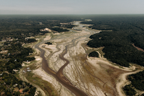 photo with aerial view of dried riverbed stretching into the distance, marked with dozens of smaller channels