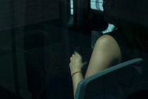 photo of a woman on the bus from outside the window