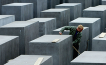 A worker at the Memorial to the Murdered Jews of Europe cleans the memorial grounds.