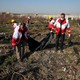 A rescue team carries a body at the site where the Ukraine International Airlines plane crashed after take-off from Iran's Imam Khomeini airport, on the outskirts of Tehran.