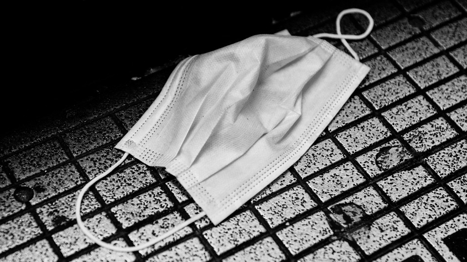 A surgical mask on the ground