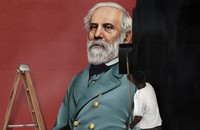 A man rolling black paint over a mural of Robert E. Lee