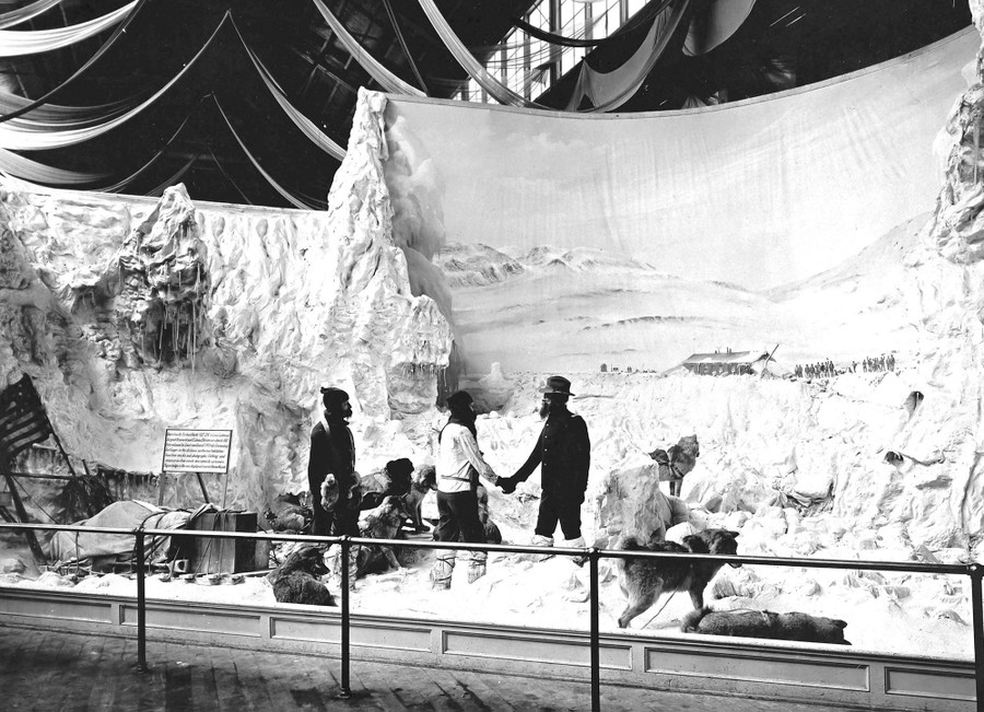 A large diorama depicting several men shaking hands in an arctic scene with sled dogs