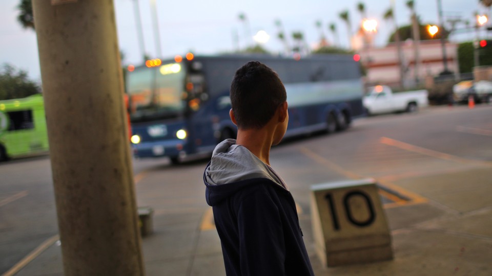 A migrant waits for a bus to Atlanta after being released from a detention center in McAllen, Texas on May 9, 2017.