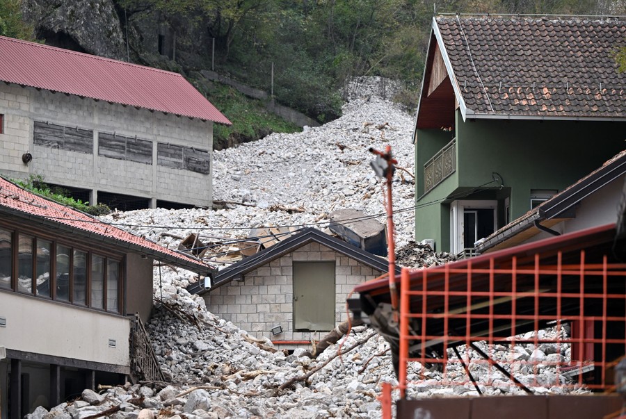 Houses engulfed by boulders after a landslide
