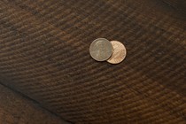 Two pennies on a wooden floor