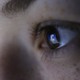 The Facebook logo reflected in a person's pupil