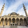 Tourists explore the courtyard of Suleymaniye Mosque in Istanbul.