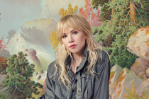 Carly Rae Jepsen against a pastel forest background