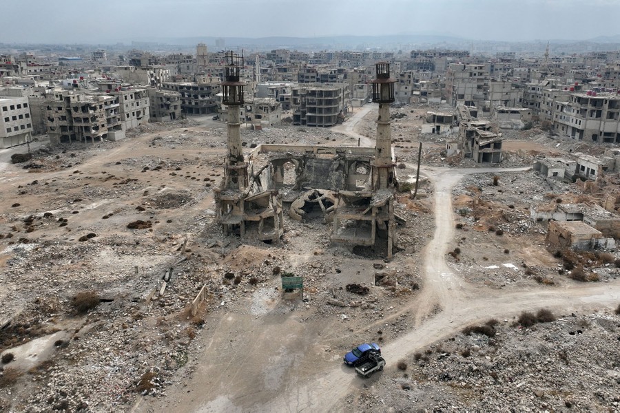 An aerial view of a mostly destroyed neighborhood in Syria, including a shattered mosque