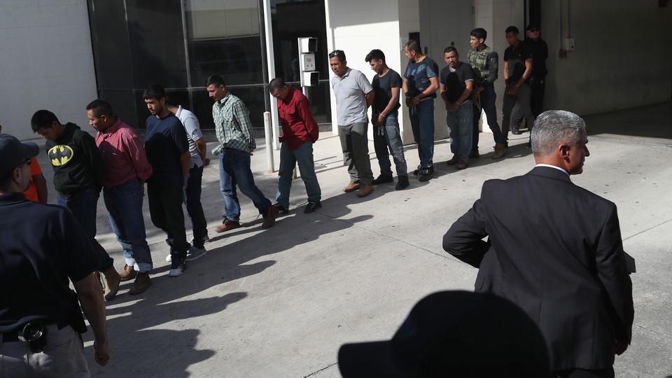 Undocumented immigrants leave a U.S. federal court in shackles in McAllen, Texas.