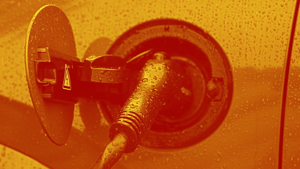 An image of an EV that is plugged into a charger