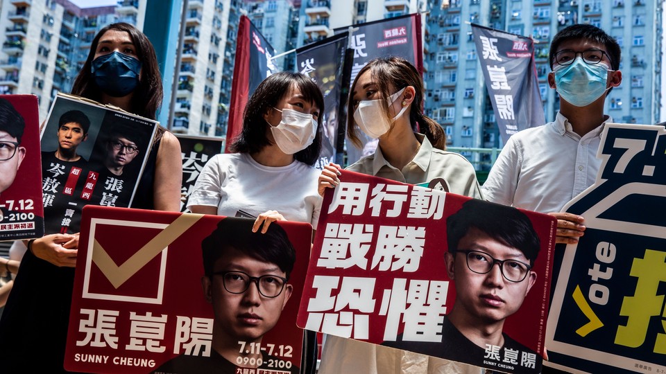 Prodemocracy activists hold signs in Hong Kong.