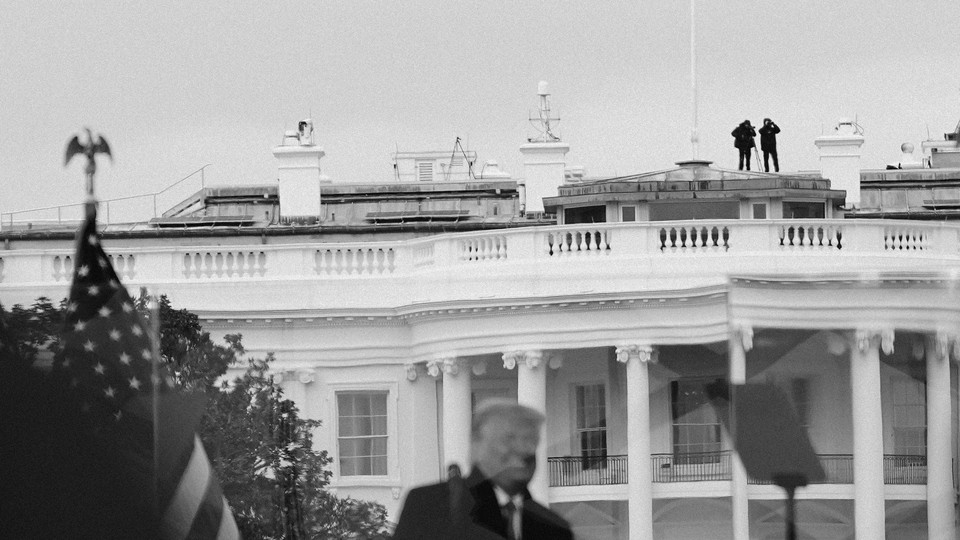 A photo of Secret Service agents on a rooftop, with Donald Trump in the foreground