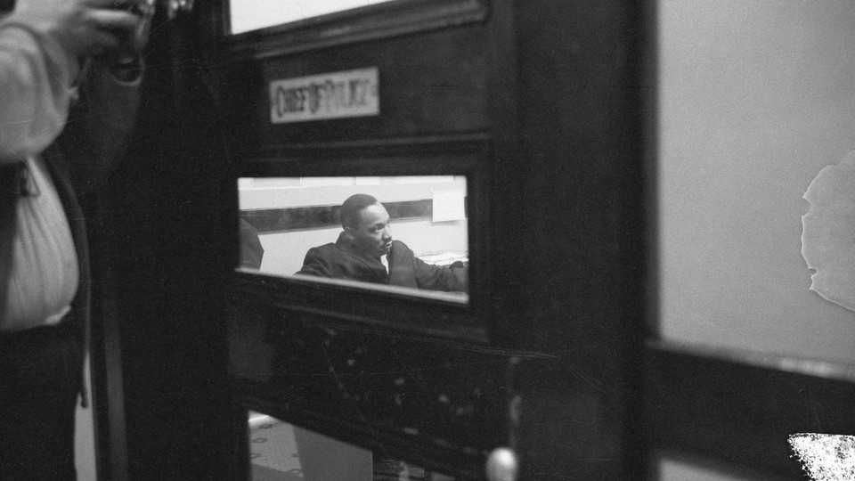 Martin Luther King Jr., seen through a small window in a door