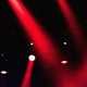 red spotlights shine against a black background